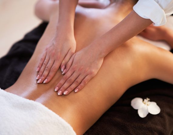 Relaxed smiling woman receiving a back massage in a spa