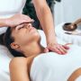 Shot of beautiful young woman having reiki healing treatment in health spa center